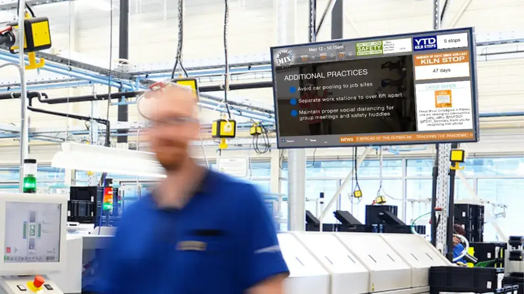 Manufacturing digital signage screen from Reach Media Network featured above machinery.