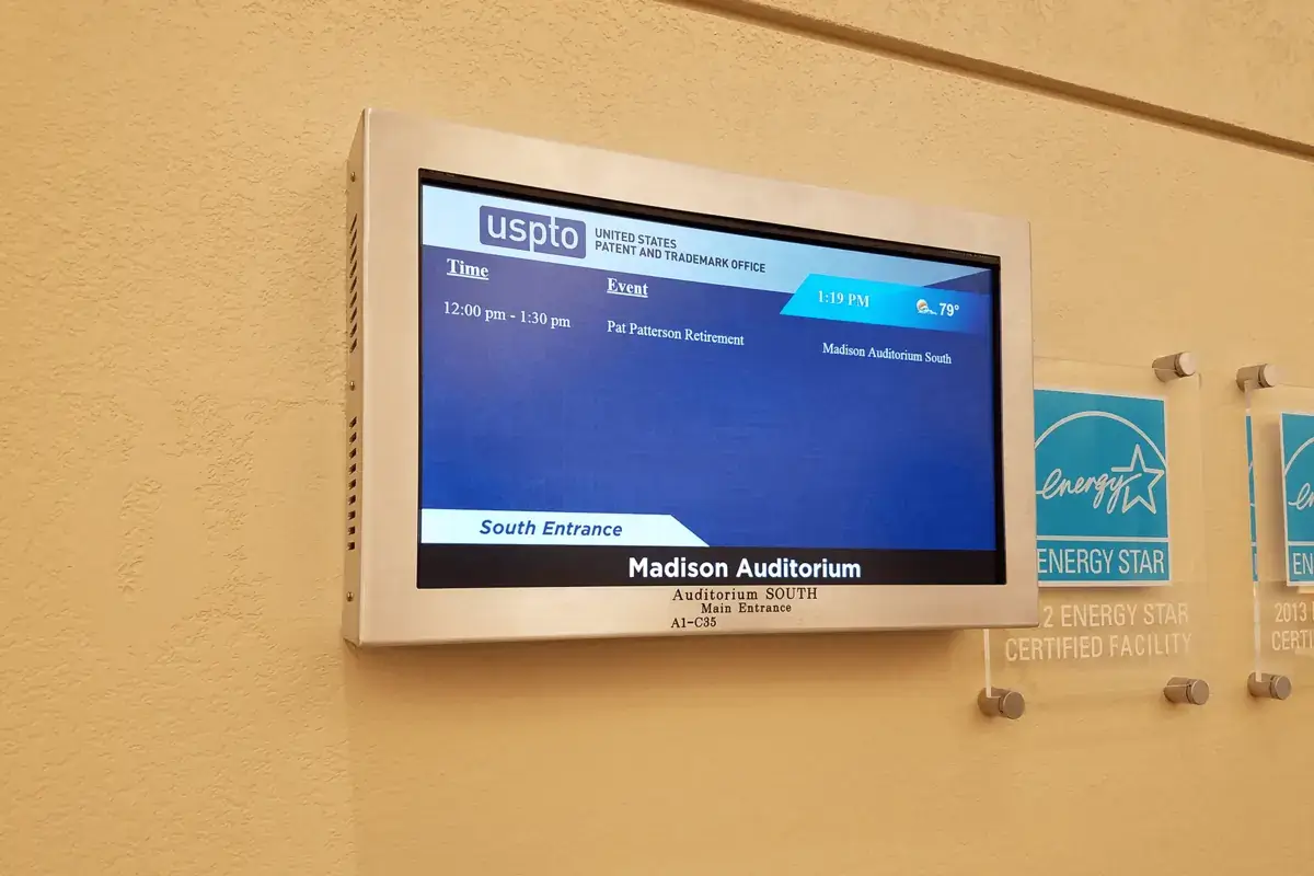 United States Patent and Trademark Office digital signage screen from Reach Media Network displaying Madison Auditorium daily events schedule.