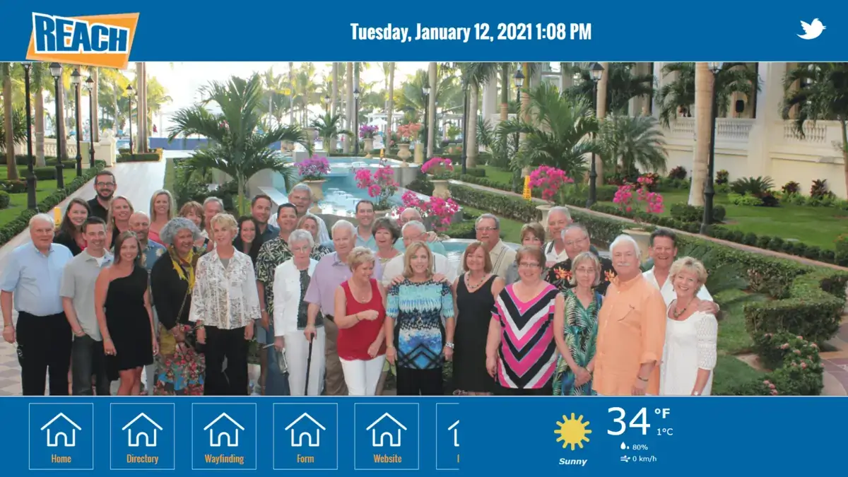 REACH Media Network digital signage touch screen displaying corporate team.