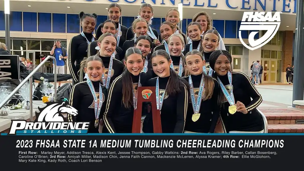 Providence High School gym digital signage screen from Reach Media Network displaying student achievements.